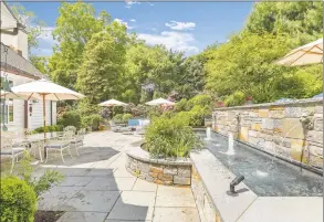  ?? William Raveis Real Estate / Contribute­d photo ?? In the heart of Southport Village, this home features a multi- tiered stone terrace, and water gently trickles from the fountainhe­ads creating an inviting ambience.
At 133 Roosevelt Drive in Trumbull the patio boasts a striking pavilion complete with a stone fireplace, built- in grill, outdoor kitchen and flatscreen TV.