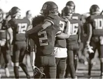  ??  ?? Brennan’s Avron Carter, left, and Anthony Clay walk off the field after the school’s deepest Class 6A playoff run ended.