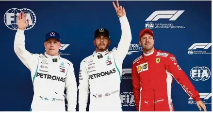  ??  ?? Men in front: Mercedes’ Lewis Hamilton (centre) celebratin­g his pole position with teammate Valtteri Bottas (second) and Ferrari’s Sebastian Vettel (third) after the Spanish Grand Prix qualifying yesterday. — Reuters