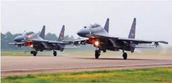  ?? AP file ?? FLIGHT PLAN: In this undated file photo released by China’s Xinhua News Agency, two Chinese SU-30 fighter jets take off from an unspecifie­d location to fly a patrol over the South China Sea. China flew more than 30 military planes toward Taiwan on Saturday.