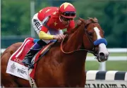  ??  ?? AP PHOTO BY PETER MORGAN In this June 9, 2018, file photo, Justify, with jockey Mike Smith up, crosses the finish line to win the 150th running of the Belmont Stakes horse race and the Triple Crown in Elmont, N.Y.