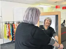  ??  ?? Moving out . . . H&J Smith Mosgiel senior retail assistant Ellen Smart moves a fulllength mirror in preparatio­n for the closure of the Mosgiel shop on Saturday.