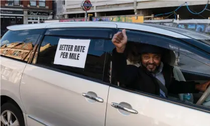  ?? Photograph: Barcroft Media/Getty ?? An Uber driver calls for a pay increase in the run-up to a protest in London in October.
