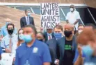  ??  ?? A Memphis prosecutor who declined to provide his name holds up a sign during the 8 minutes and 46 seconds of silence for George Floyd, who died in Minneapoli­s after a now-fired police officer kneeled on his neck.