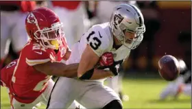  ?? (AP/Charlie Riedel) ?? Kansas City Chiefs cornerback Mike Hughes (left) forces a fumble by Las Vegas Raiders wide receiver Hunter Renfrow in the first half Sunday at Arrowhead Stadium in Kansas City, Mo. The Chiefs’
defense forced five turnovers in a 48-9 victory.