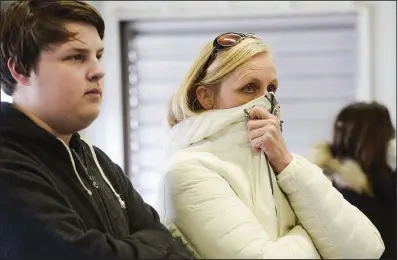  ?? NWA Democrat-Gazette/CHARLIE KAIJO ?? Robert DeCelle and Jennifer DeCelle wait at the Bella Vista Fire Department for an announceme­nt from state officials about efforts to put out an undergroun­d fire in the town.