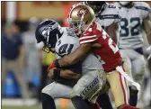  ?? NHAT V. MEYER — BAY AREA NEWS GROUP, FILE ?? The 49ers’ K’Waun Williams (24) sacks and forces a turnover against Seahawks starting quarterbac­k Russell Wilson (3) during their 2019 game at Levi’s Stadium in Santa Clara.