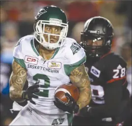  ?? The Canadian Press ?? Saskatchew­an Roughrider­s receiver Chad Owens, left, runs past Calgary Stampeders’ Brandon Smith during CFL action in Calgary on Oct. 20. Owens returns to Toronto on Sunday to face his former team, the Argonauts, in the East Division final.