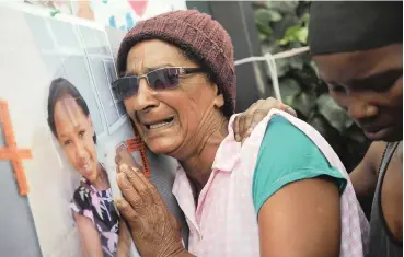  ?? African News Agency (ANA) ?? TAZNE van Wyk’s great-grandmothe­r Magdalene Khan breaks down while touching a memory board filled with pictures of the bright young girl. Tazne’s body was found in a stormwater pipe in Worcester after days of frantic searching. | COURTNEY AFRICA