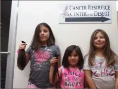  ?? PHOTO ANDY VELEZ ?? FROM LEFT: Velazco sisters Rhyanna, 9; Rhoswen, 5, and Milley, 8, pose together at Saturday’s backto-school event. Rhyanna and Rhoswen are shown holding locks of hair they planned to donate for cancer victims.