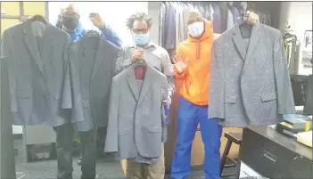  ??  ?? (From left) Doe Fund resident Michael Smith, staffer Joseph Calhoun and resident George Thomas, with some of Alex Trebek’s suits that were shipped to the New York City non-profit last month. — The Washington Post photo courtesy of the Doe Fund
