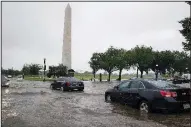  ?? AP/ALEX BRANDON ?? Heavy rainfall Monday flooded the intersecti­on of 15th Street and Constituti­on Avenue Northwest in Washington, D.C., causing cars to stall near the Washington Monument.