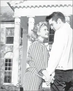  ?? ROBERT WILLIAMS/ THE COMMERCIAL APPEAL FILES ?? Hollywood starlet Yvonne Lime and Elvis Presley gaze lovingly upon each other on April 19, 1957, in front of Graceland, Elvis’ new $100,000 mansion near Whitehaven. Miss Lime, who was visiting for the Easter holidays, had a small part in “Loving You,”...