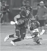  ?? CHERYL EVANS/THE REPUBLIC ?? Chandler’s Gunner Maldanado breaks a tackle by Queen Creek’s Dartanyon Sneed during Friday night’s game at Chandler High.