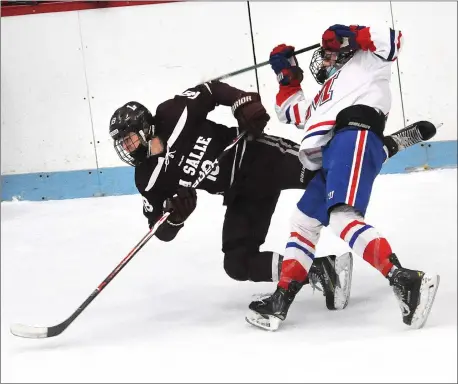  ?? Photos by Ernest A. Brown ?? The Mount St. Charles hockey team found itself in a two-goal hole after one period Friday night against No. 4 La Salle, but thanks to the play of Eddie Mulligan (4), Matt Mahoney (12) and Micaiah Bascombe, the Mounties took Game 1 of the state semifinal series 3-2 in overtime.