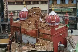  ?? — PTI ?? A portion of Masjid Mubarak Begum collapses due to incessant rains at Hauz Qazi Chowk in old Delhi on Sunday.