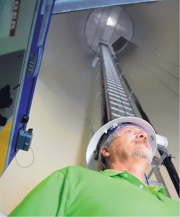  ??  ?? Avangrid spokesman Art Sasse stands on the base floor inside a wind turbine tower at El Cabo Wind Farm.