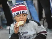  ?? JOHN MOORE / GETTY IMAGES ?? A Salvadoran boy, 6, eats a free breakfast outside a temporary shelter Saturday in Tijuana, Mexico, part of the migrant caravan.