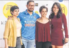  ??  ?? Actor Aamir Khan poses with wrestlers Ritu and Geeta Phogat at the MAMI Film Festival in Mumbai on Sunday.