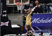  ?? BRANDON DILL — THE ASSOCIATED PRESS ?? Warriors guard Jordan Poole, right, shoots against Grizzlies forward Justise Winslow in the first half on Saturday in Memphis, Tenn.