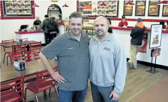  ?? JESSICA NYZNIK/EXAMINER ?? Jason Taylor, left, and Cory Stillman pose for a photo in their newest Firehouse Subs on Lansdowne St. W. on Monday. The eatery, next to the Sunset Grill in the Byersville Creek Plaza, opened Monday.