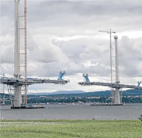  ??  ?? ALMOST TOUCHING: A view of the new Queensferr­y Crossing, the new bridge across the Forth. The £1.3bn project is due to open in May next year.