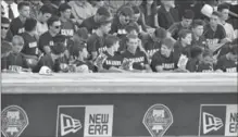  ?? STEVE NESIUS, THE ASSOCIATED PRESS ?? Calvary Christian High School baseball players sit above the dugout during a memorial tribute for Roy Halladay in Clearwater, Fla.