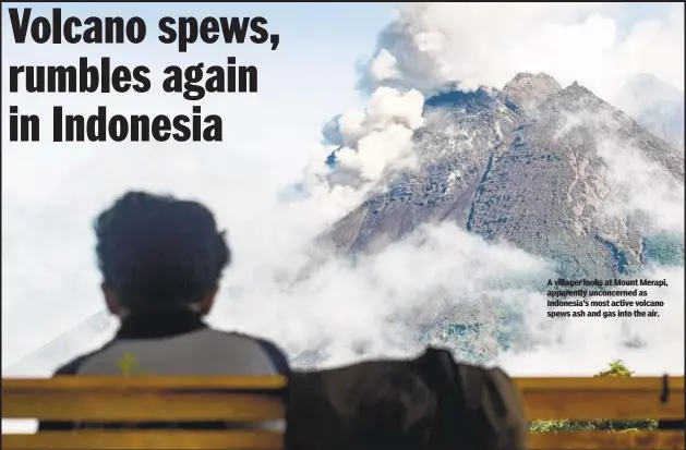  ?? ?? A villager looks at Mount Merapi, apparently unconcerne­d as Indonesia’s most active volcano spews ash and gas into the air.