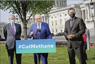  ?? SENATE J. Scott Applewhite Associated Press ?? Majority Leader Charles E. Schumer, flanked by fellow Democratic Sens. Edward J. Markey, left, and Martin Heinrich, discusses the move to tighten methane regulation­s under the Congressio­nal Review Act.