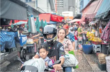  ?? REUTERS ?? People shop at a market in Bangkok as Thailand gears up to inject 500 billion baht into the economy in 4th quarter of this year through its digital wallet policy.