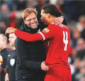  ?? Reuters ?? Liverpool manager Juergen Klopp celebrates with Virgil van Dijk at the end of the FA Cup third round clash against Everton at Anfield on Friday.