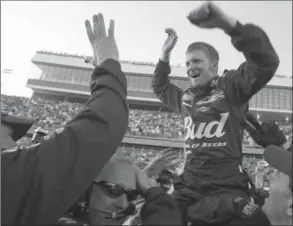  ?? KELLY JORDAN, THE ASSOCIATED PRESS ?? Dale Earnhardt, Jr. celebrates withhis crew after winning the Daytona 500, on Feb. 15, 2004.