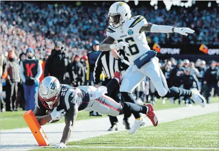  ?? ADAM GLANZMAN GETTY IMAGES ?? Sony Michel of the New England Patriots scores one of his three touchdowns on Sunday against the Los Angeles Chargers in Massachuse­tts. The Patriots, powered by the arm of quarterbac­k Tom Brady and the coaching of Bill Belichick, will face Kansas in the AFC title game.