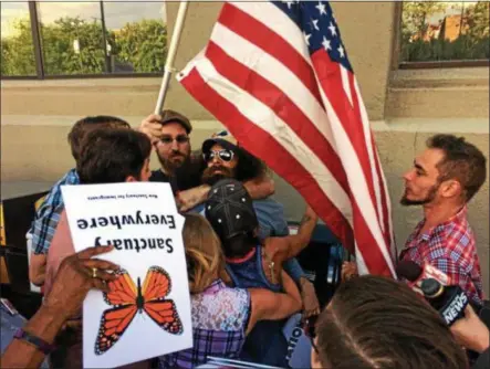  ?? RECORD FILE PHOTO. ?? People clash over Troy becoming a sanctuary city before a City Council meeting in 2017.