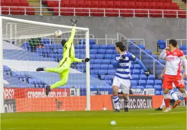  ??  ?? A header loops over Reading keeper Rafael Cabral as Millwall snatch a late winner to take the points