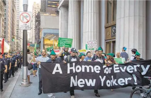  ?? GETTY IMAGES ?? Banner carried by demonstrat­ors from Zuccotti Park to City Hall expresses newfound hope now that Democrats are in full control in Albany.