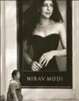  ?? AP PHOTO ?? A woman walks past a Nirav Modi boutique in Mumbai, February 15.