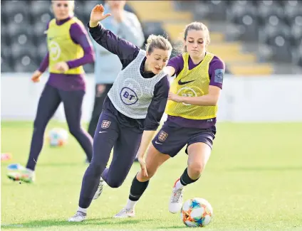  ?? ?? Busy bees: Ellen White (left) competes for the ball with team-mate Ella Toone during an England training session at the Hive in Barnet