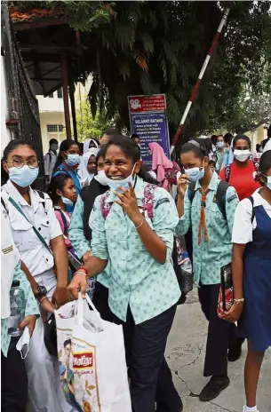  ??  ?? Early dismissal: SMK Convent Light Street students with their face masks walking out from school after being allowed to go home early due to the deteriorat­ing API in George Town.