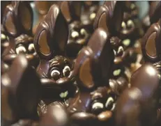  ?? VIRGINIA MAYO/ASSOCIATED PRESS ?? CHOCOLATE RABBITS wait to be decorated at the Cocoatree chocolate shop on April 8, 2020, in Lonzee, Belgium. Sweet Easter baskets will likely come at a bitter cost this year for consumers as the price of cocoa climbs to record highs.