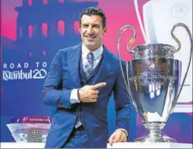  ??  ?? Luis Figo poses with the Champions League trophy before the R16 draw in Nyon, Switzerlan­d.
REUTERS