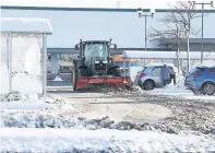  ??  ?? Supermarke­t sweep A tractor clears the car park at Morrisons Lindsayfie­ld