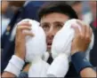  ?? FRANK FRANKLIN II — THE ASSOCIATED PRESS ?? Novak Djokovic, of Serbia, puts an ice towel to his face during a changeover in his match against Marton Fucsovics, of Hungary, during the first round of the U.S. Open tennis tournament, Tuesday in New York.