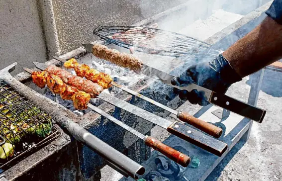  ?? Santiago Mejia/The Chronicle ?? Ahmad Yaseen makes kebabs at the original Mazra in San Bruno in 2022. The new location boasts a 22-foot custom grill.