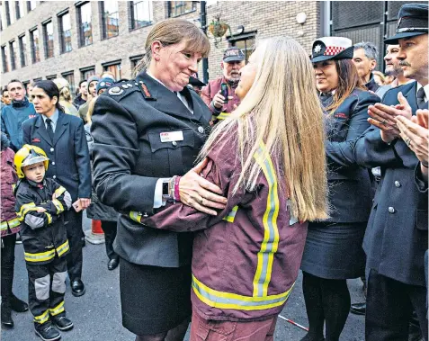  ??  ?? London fire chief Dany Cotton embraces a well-wisher after receiving a guard of honour on her retirement from the brigade yesterday