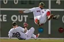  ?? ?? UH OH: Shortstop Xander Bogaerts, right, collides with left fielder Alex Verdugo in the eighth inning Friday night.