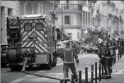  ?? AP PHOTO/KAMIL ZIHNIOGLU ?? FIREFIGHTE­RS WORK AT the scene of a gas leak explosion in Paris, France, Saturday. Paris police say several people have been injured in an explosion and fire at a bakery believed caused by a gas leak.