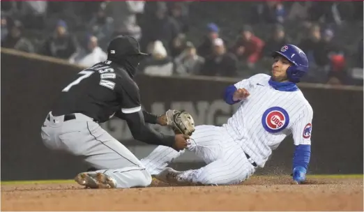  ?? GETTY IMAGES ?? White Sox shortstop Tim Anderson tags out Cubs baserunner Nick Madrigal at second base on a double play in the fifth inning Tuesday at Wrigley Field.