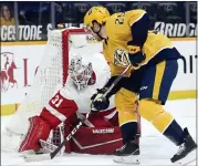  ?? MARK ZALESKI — THE ASSOCIATED PRESS ?? Detroit Red Wings goaltender Calvin Pickard (31) blocks a shot by Nashville Predators right wing Mathieu Olivier (25) during the second period of Thursday’s game in Nashville, Tenn.