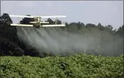  ?? DAVE MARTIN — THE ASSOCIATED PRESS FILE ?? A crop duster sprays a field in Alabama.